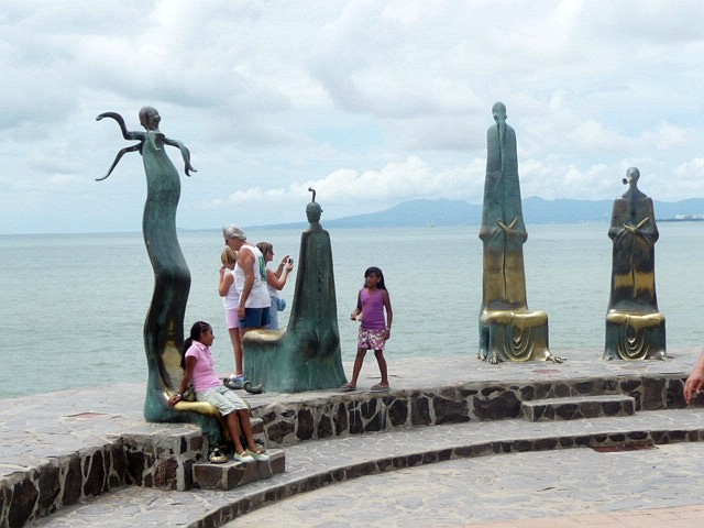 SEATED IN THE STATUE ON THE BEACH OF PUERTO VALLARTA MEXICO